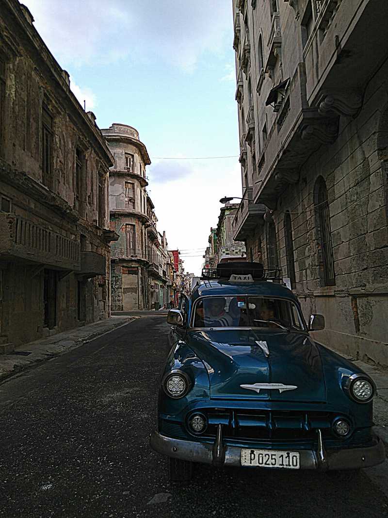 Old car in old street.